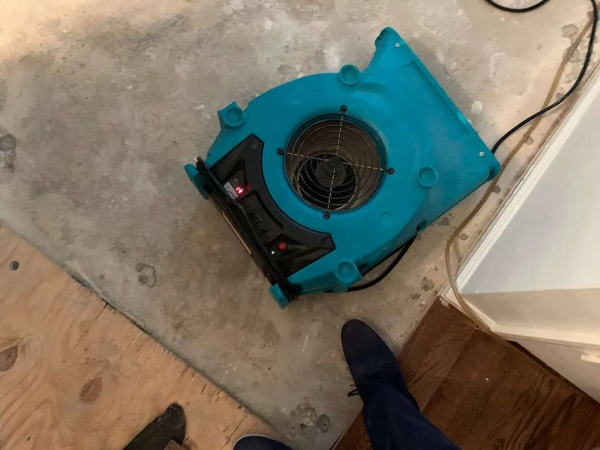 Air mover drying subfloor during Commercial Water Damage Restoration in Pittsboro
